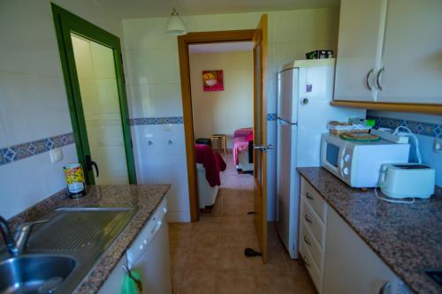 eine Küche mit Spüle und Kühlschrank in der Unterkunft Precioso ático en la Sierra de Irta in Alcossebre