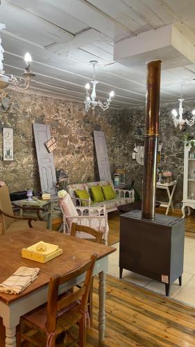 a room with a table and a wood stove at Holiday House Prodromos in Prodromos
