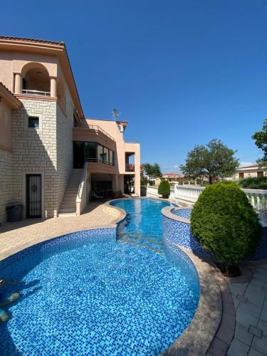 a swimming pool in front of a house at Luxury Villa Ulcinj in Ulcinj