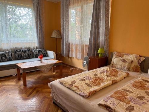 a living room with two beds and a couch at Rose Garden in Siófok