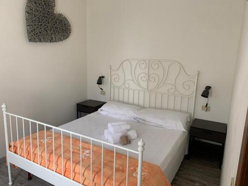 a bedroom with a white bed with two night stands at Agriturismo Ca' Alleata in Caorle