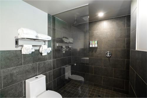 a bathroom with a toilet and a shower at Ruby River Hotel in Spokane