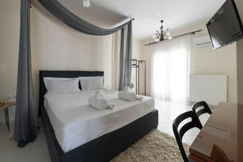 a bedroom with a bed with two towels on it at Amazing view with huge balcony in Veria