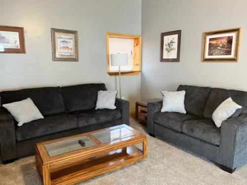 a living room with two couches and a coffee table at Stay In Ohiopyle - closest place to the GAP trail in Ohiopyle, PA in Farmington