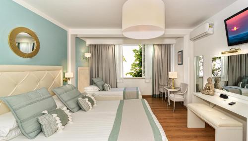 A bed or beds in a room at Raffaelli Park Hotel