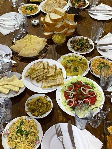 a table with plates of food on it at Nizharadze's Tower in Ushguli