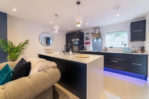 a kitchen with a counter and a couch in a room at Llanberis Lodges in Llanberis