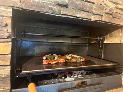 a plate of food is cooking in an oven at Luxus Apartment Nina mit Zirbenhütte in Ramsau im Zillertal