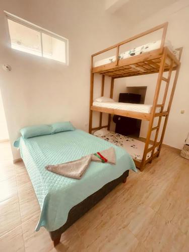 a bedroom with two bunk beds in a room at Hostal Badillo SV in Cartagena de Indias