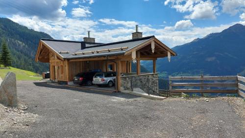 a building with a car parked in front of it at Panorama Berg Chalet in Großkirchheim