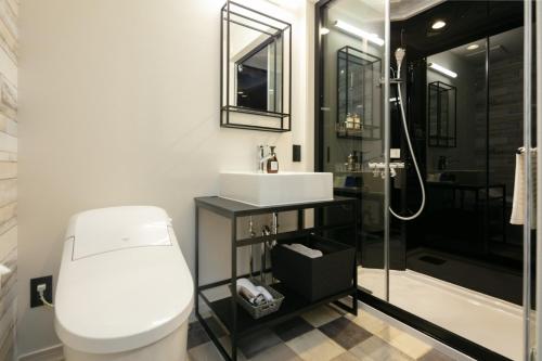 a bathroom with a toilet and a sink and a shower at HOTEL TABARD TOKYO - Vacation STAY 62622v in Tokyo