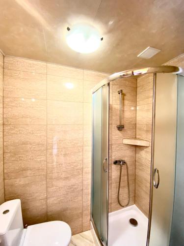 a bathroom with a shower and a toilet at Pokoje goscinne Marcin in Łeba