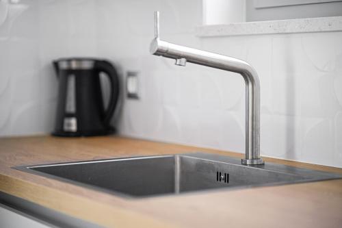 a kitchen sink with a faucet on a counter at Perla Luxury Apartment in Vodice