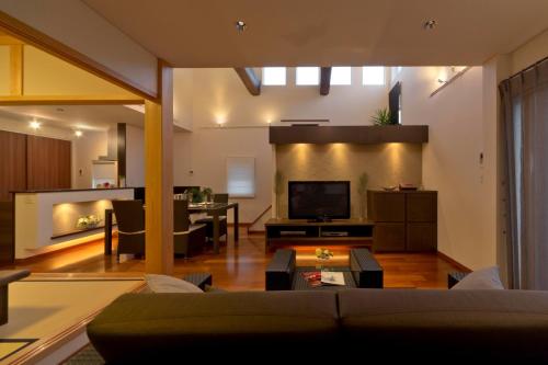 a living room with a couch and a tv at villa-rizo - Vacation STAY 13184 in Hida