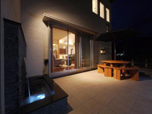 a patio at night with a table and a bench at villa-rizo - Vacation STAY 13184 in Hida