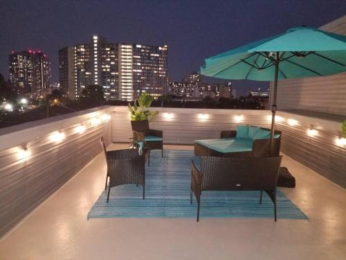 a rooftop patio with a table and chairs and an umbrella at THE ROOFTOP OASIS in Philadelphia