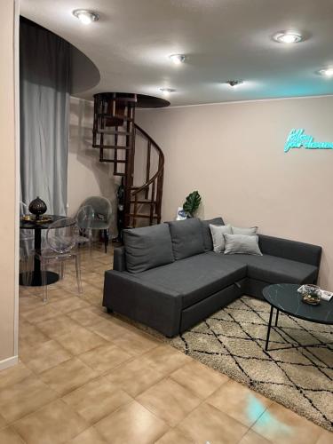 a living room with a couch and a spiral staircase at Adream in Pescara