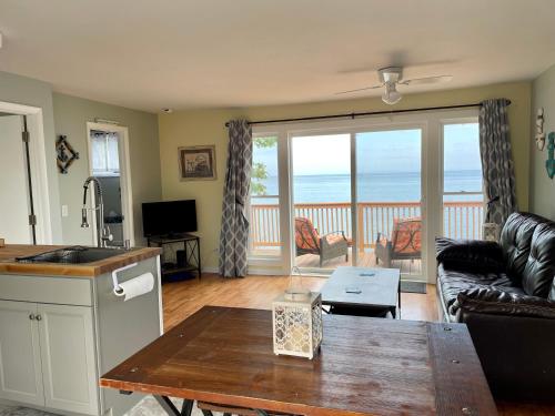 a living room with a view of the ocean at Cozy LAKE ONTARIO WATERFRONT Breathtaking Views! in Pulaski