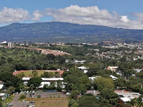 an aerial view of a city with a mountain at Boho Chic, Apart- condo cerca de SJO Intl airport in Barrial