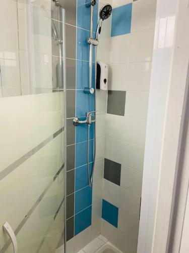 une salle de bain avec une douche avec une porte vitrée dans l'établissement Villa Yvonne M&M à 50m de la plage, à Mers-les-Bains