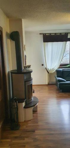 a living room with a wood stove in a room at Haus Anicka zum Bömerwaldjeti in Aigen im Mühlkreis