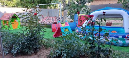 a childrens play set in a backyard at Agropensiunea Olteanu in Niculiţel