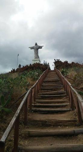 a staircase leading up to a statue on a hill at Suites Pinto Coelho in Caniço