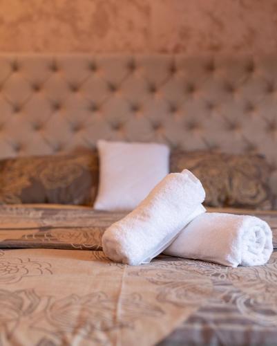 two beds with a rolled up towel on the bed at Delux Apartmani Požarevac in Požarevac