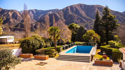 a swimming pool in a garden with mountains in the background at Casa Miranda in Miranda