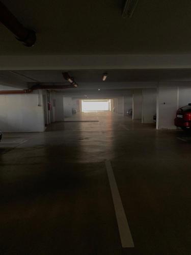 an empty parking garage with a car parked in it at Apartment Rose in Sesvete