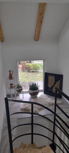 a dining room with a table and a window at Ravne weekend house in Visoko