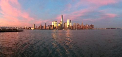 a view of a city from the water at sunset at Sonesta Simply Suites Jersey City in Jersey City
