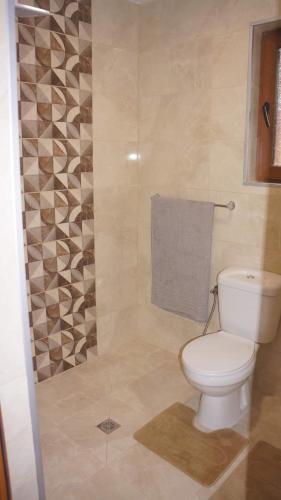 a bathroom with a toilet and a towel at КРУШУНСКИ КЪТ ТЕЯ in Krushuna