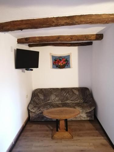 a living room with a couch and a table at Borlova /Muntele Mic in Borlova