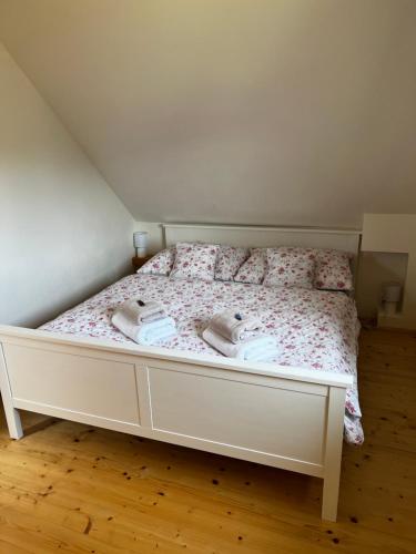 a bedroom with a bed with two towels on it at Chata Nechata in Velhartice