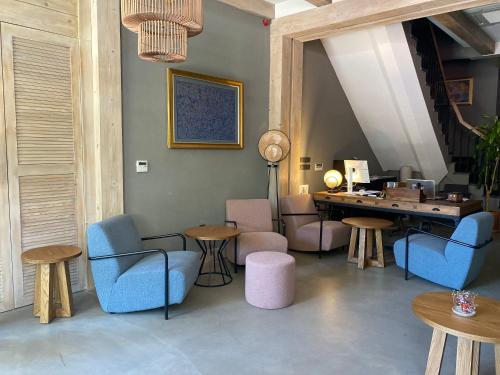 a room with chairs and tables and a desk at Istanbul Old City Colorful Houses Balat PETRION Hotel in Istanbul