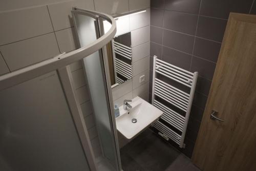 a bathroom with a sink and a mirror at New Pension at ROTOR Brewery in Kunovice
