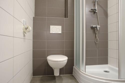 a small bathroom with a toilet and a shower at New Pension at ROTOR Brewery in Kunovice