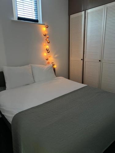 a bedroom with a white bed with lights on it at Canal apartment at historic CityCenter Amersfoort in Amersfoort