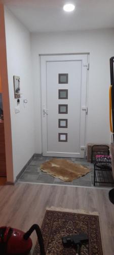 a room with a white door with a rug in front at Ravne weekend house in Visoko
