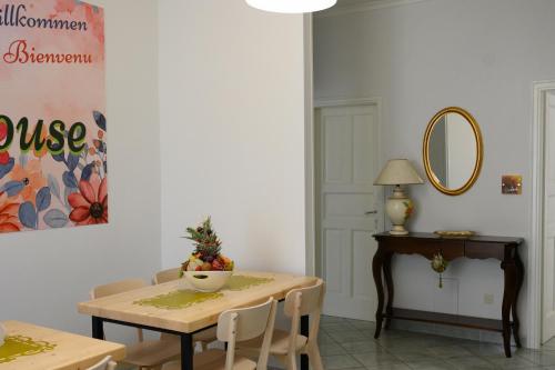 a dining room with a table and a mirror at Flowers' House in Castellammare di Stabia
