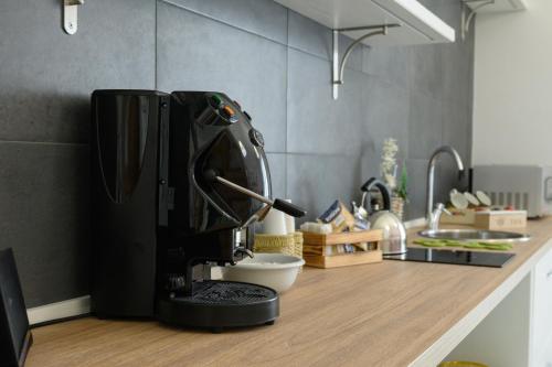 a black mixer sitting on a counter in a kitchen at Flowers' House in Castellammare di Stabia