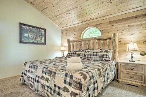a log cabin bedroom with a bed and a window at Furnished Deck and Grill Rustic Pigeon Forge Cabin in Pigeon Forge