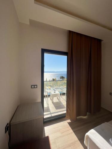 a bedroom with a bed and a view of the ocean at Life Point Hotel in Çeşme