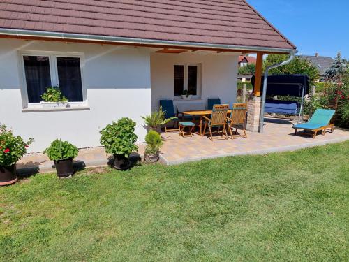 a house with a patio with a table and chairs at Pol-Lak in Szőlősgyörök