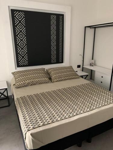 a bedroom with a large bed in a room at La maison del corso in Santa Teresa Gallura
