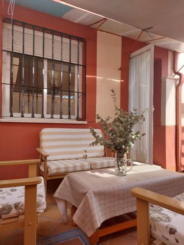 a living room with two tables and a window at Alojamiento en Bujalance in Bujalance