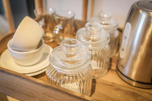 a wooden counter with glass jars on top of it at Hope and Anchor in Flookburgh