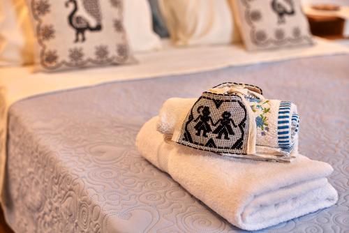 a pile of towels sitting on top of a bed at al VICOLO VI in Sardara