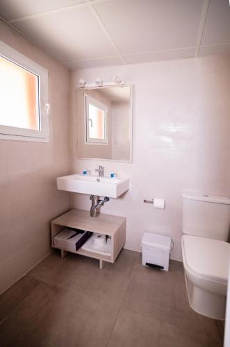 a bathroom with a sink and a toilet at Sant Joan Apartaments - Adults Only in Cala en Blanes